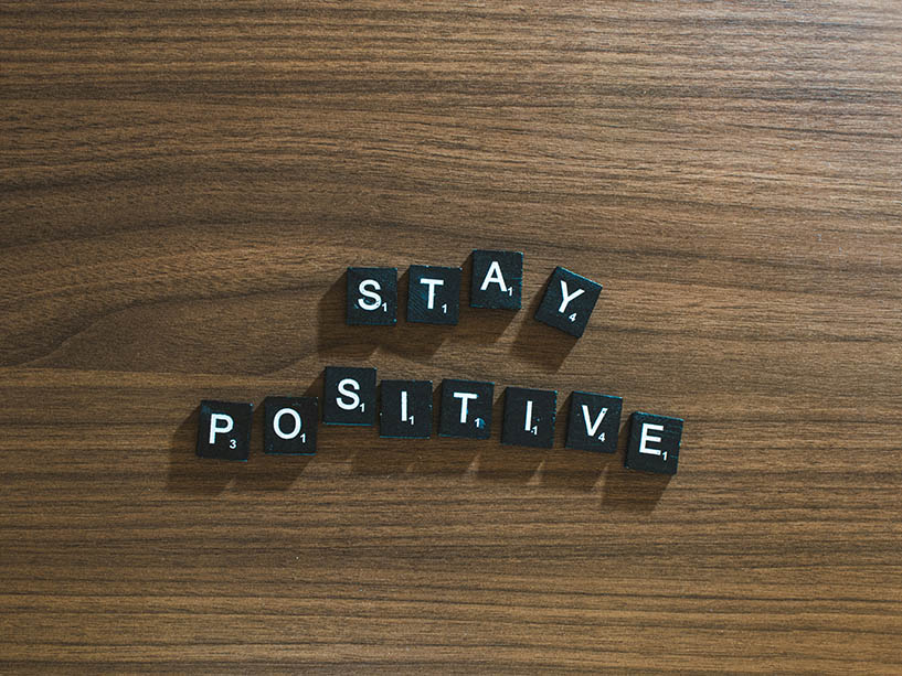 The words “stay positive” arranged in individual letters.