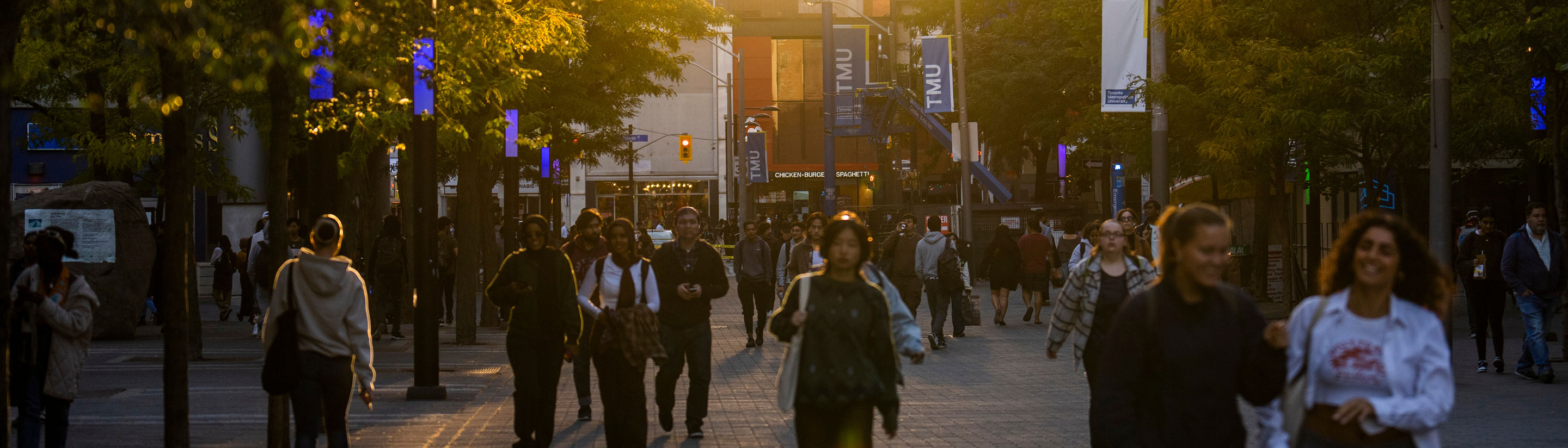 a bustling Gould street with TMU banners