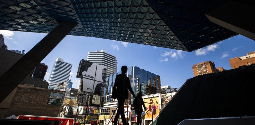 Yonge-dundas square, silhoette of people walking towards underground enterence to Dundas subways station