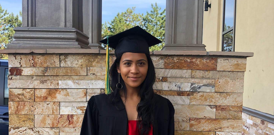 Nishka with a graduation cap and gown