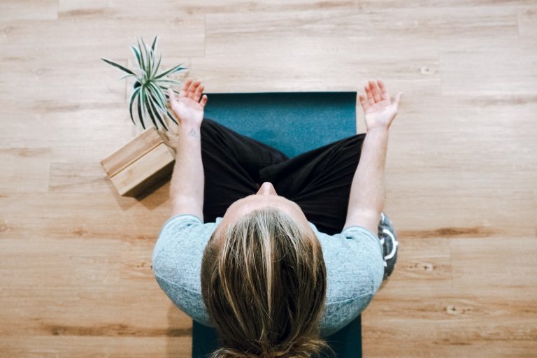 Person meditating with their legs crossed