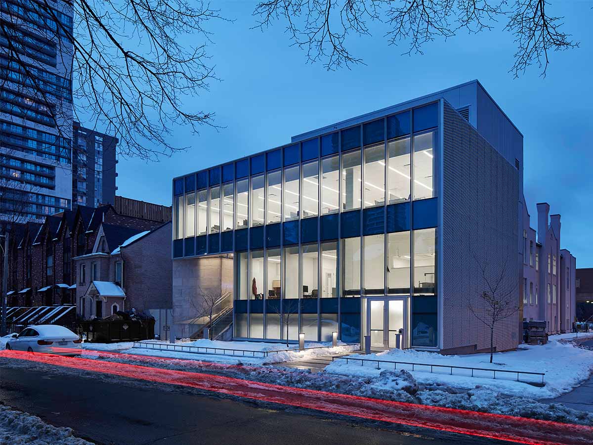 A car drives past the Centre for Urban Innovation on a  winter's evening