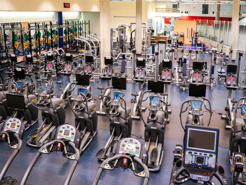 Rows of power/squat racks, elliptical machines and other gym equipment in the Mattamy Athletic Centre