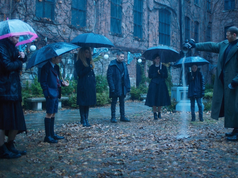 The filming of the show the Umbrella Academy in Toronto with all the kids using umbrellas standing together