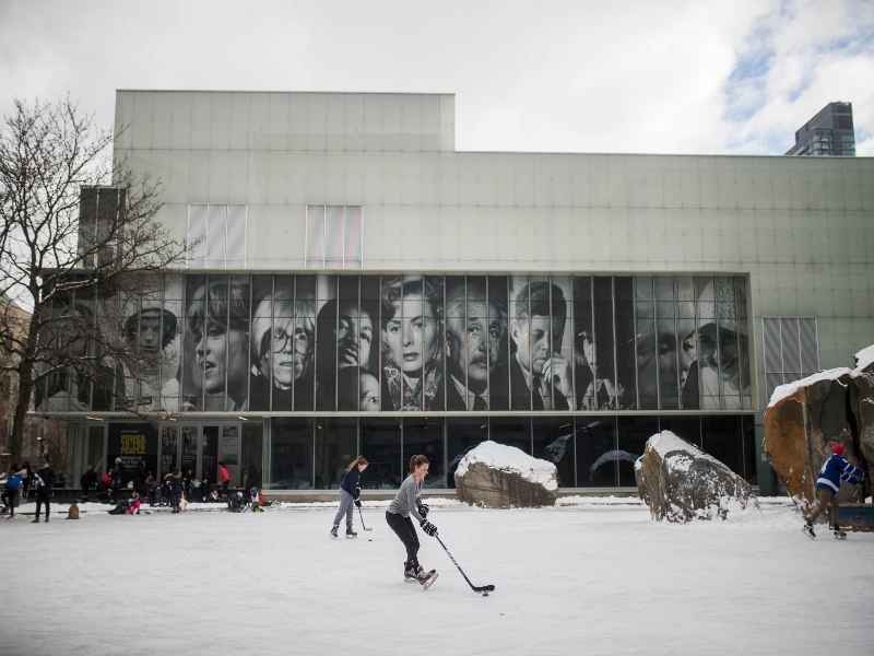 Students skating and playing hockey Lake Devo in the winter