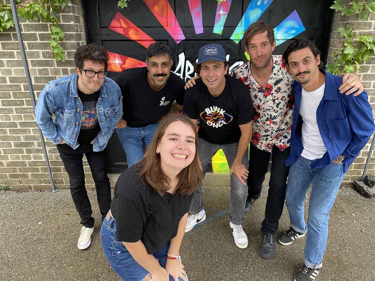 Jenna posing for a photo with the Arkells!