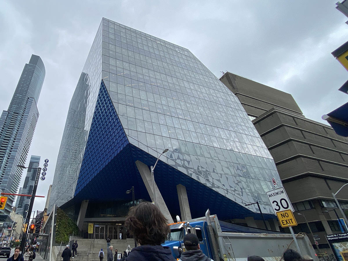 The glass geometric Student Learning Centre stands at Yonge and Gould on a cloudy day.