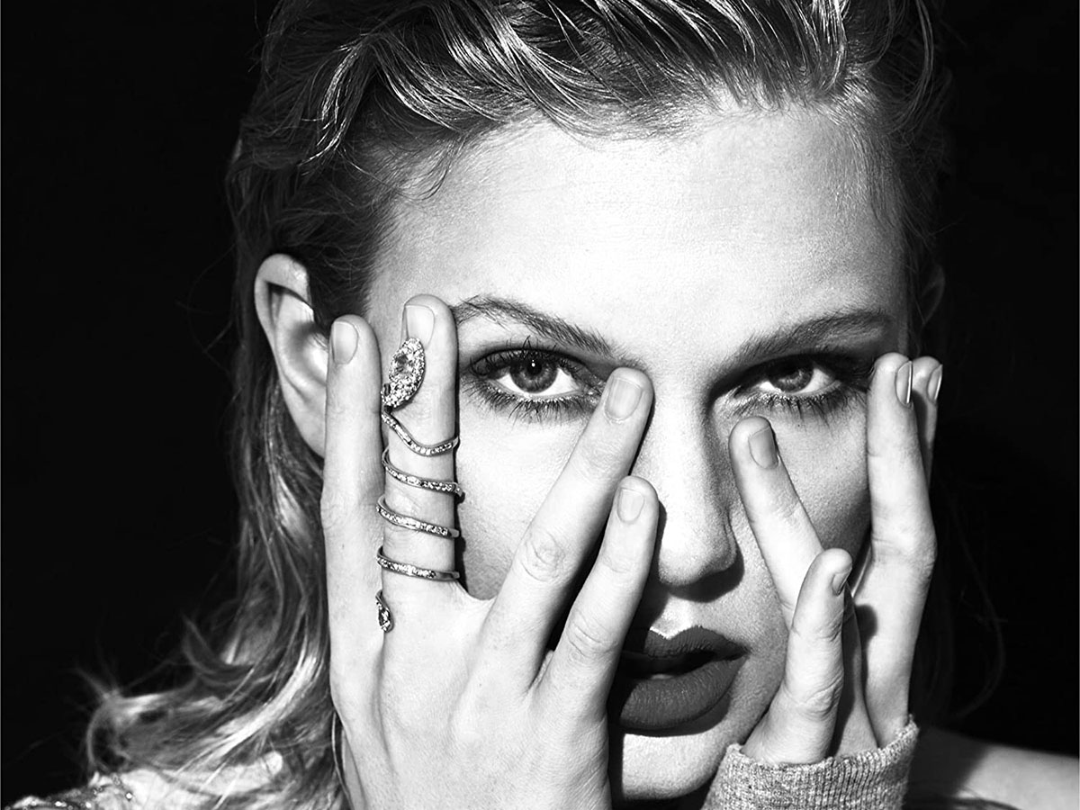 Taylor Swift with a snake ring around one of her fingers during her darker "reputation" era.