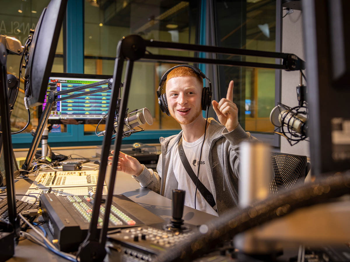 A student uses the recording equipment in the Allan Slaight Radio Institute.