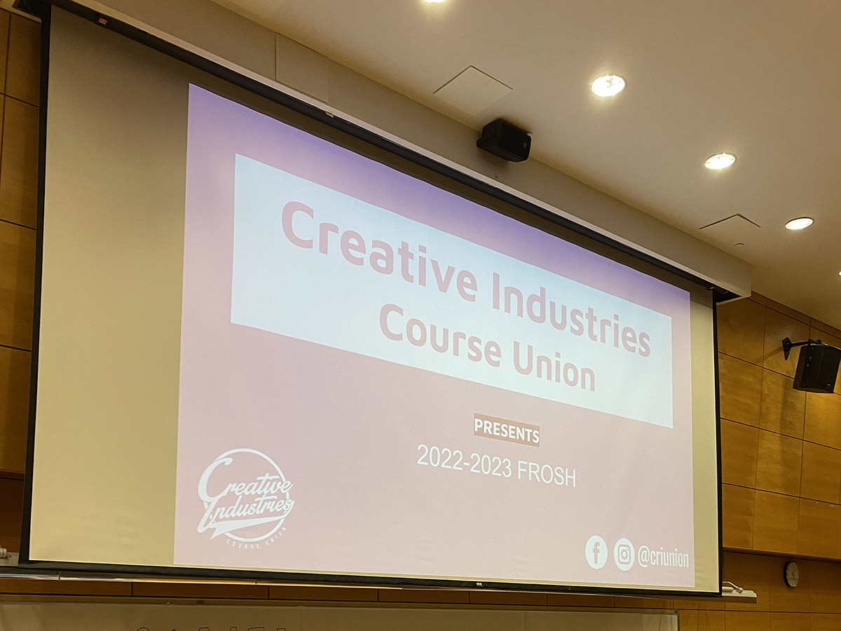 The welcome slide for the 2022-2023 Creative Industries Course Union frosh on a projector in an auditorium.