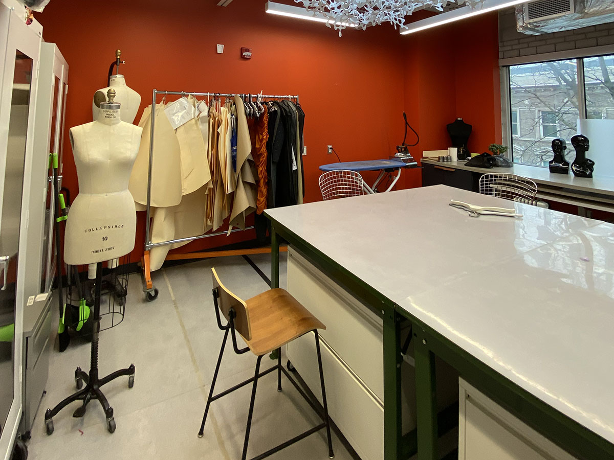 A dress form and garments in a sewing room in the Fashion Zone.