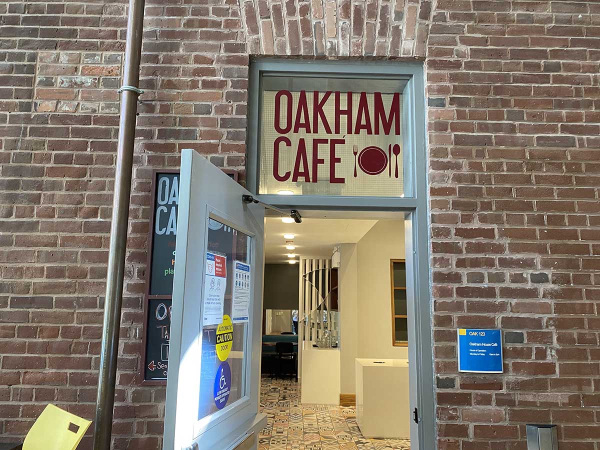 The entrance to Oakham Café among a brick wall inside of the Student Campus Centre.