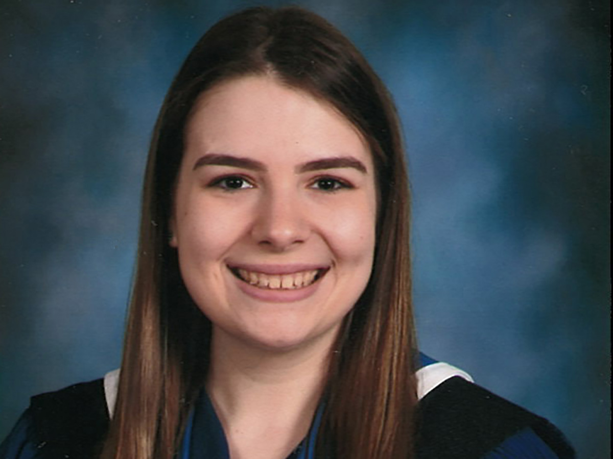 Jenna posing for a graduation photo.