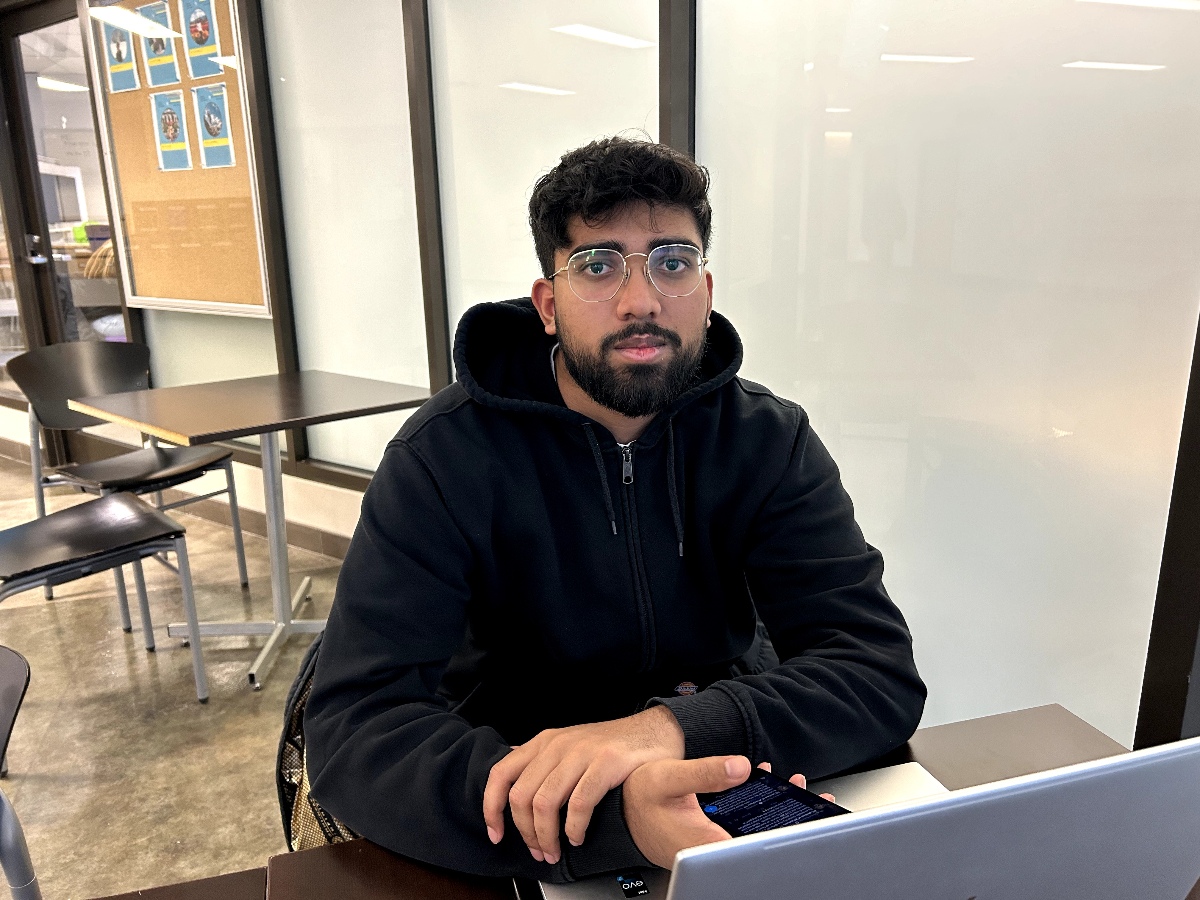 Joseph working on his laptop in the TRS building.