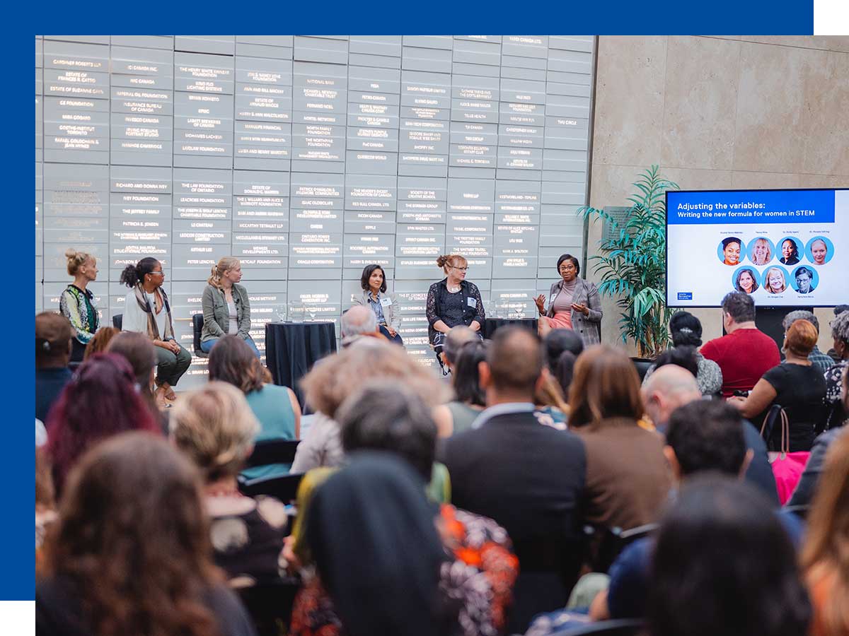 Leaders working in STEM gathered to discuss solution for gender inequity in front of a seated audience.