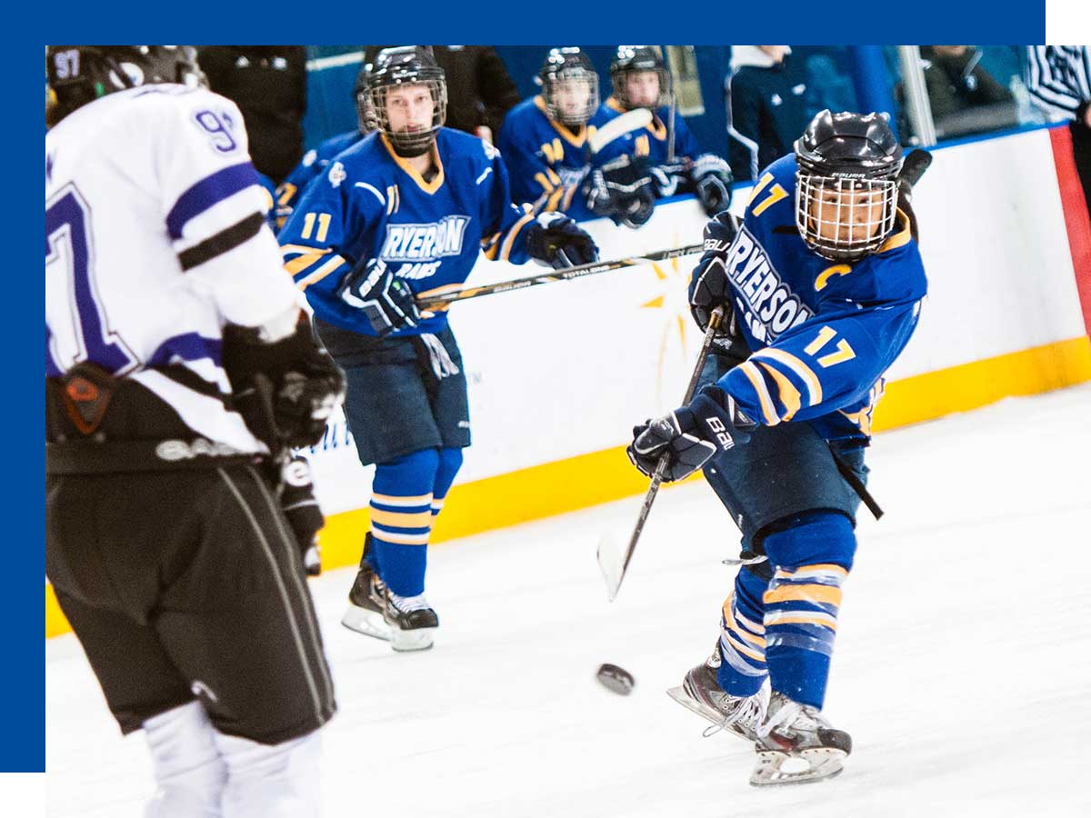 Nella Brodett, wearing full hockey gear, skates on ice during a women’s hockey game against Western University.