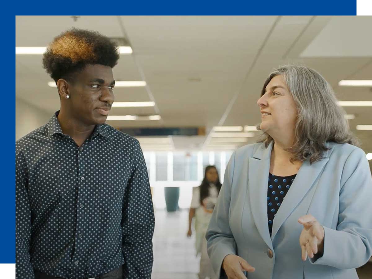 Student Terel Leslie (left) walks with Cynthia Holmes, dean of the Ted Rogers School of Management.