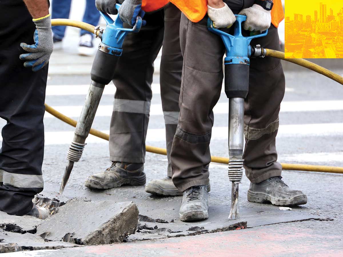 The Forefront — workers breaking asphalt using jackhammers