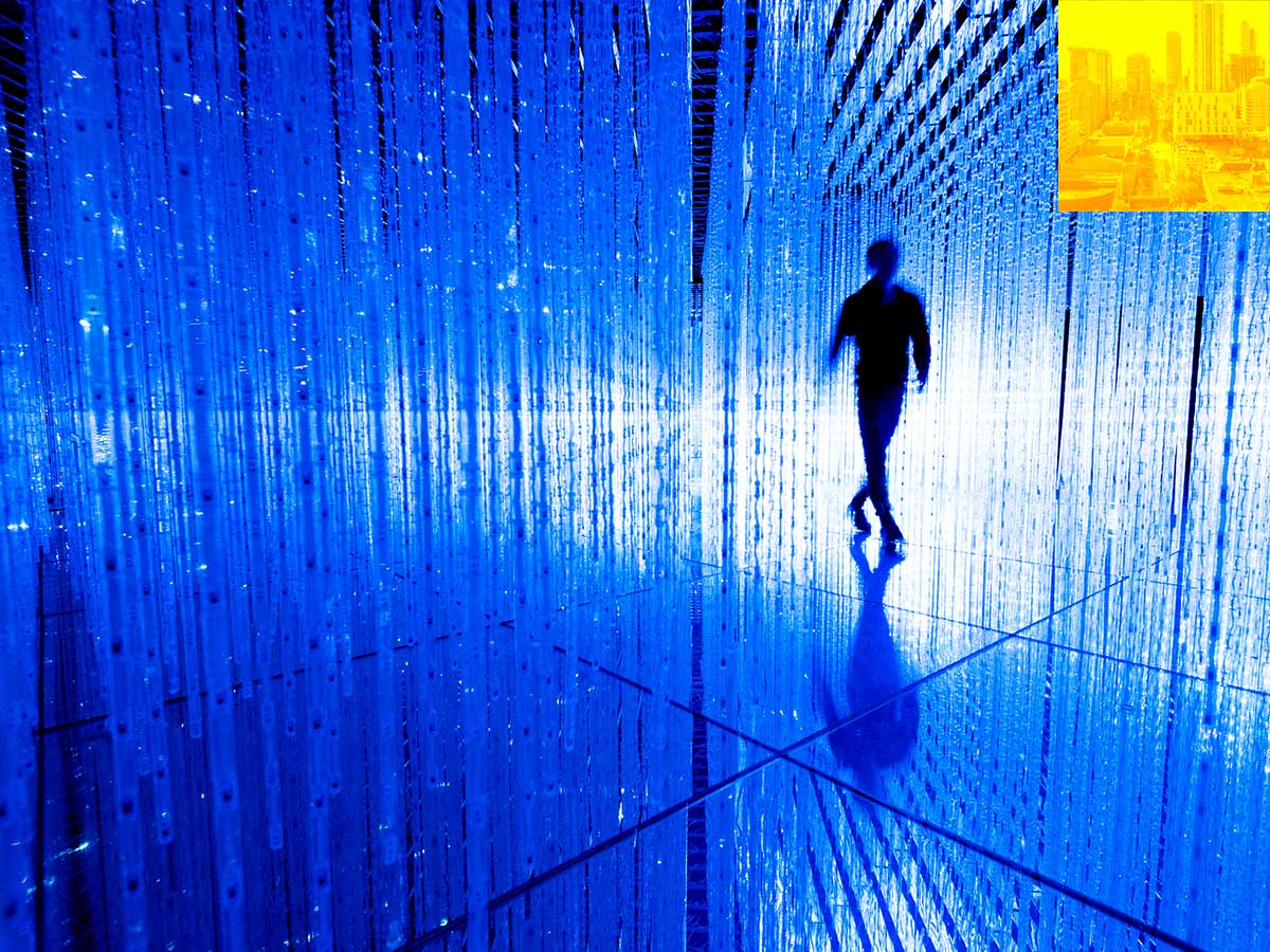 silhouette of person walking within a room with glowing lights and mirrors