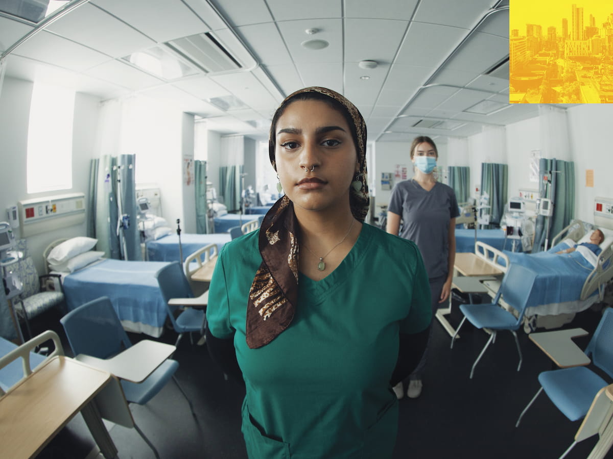 People in medical smocks in a hospital room