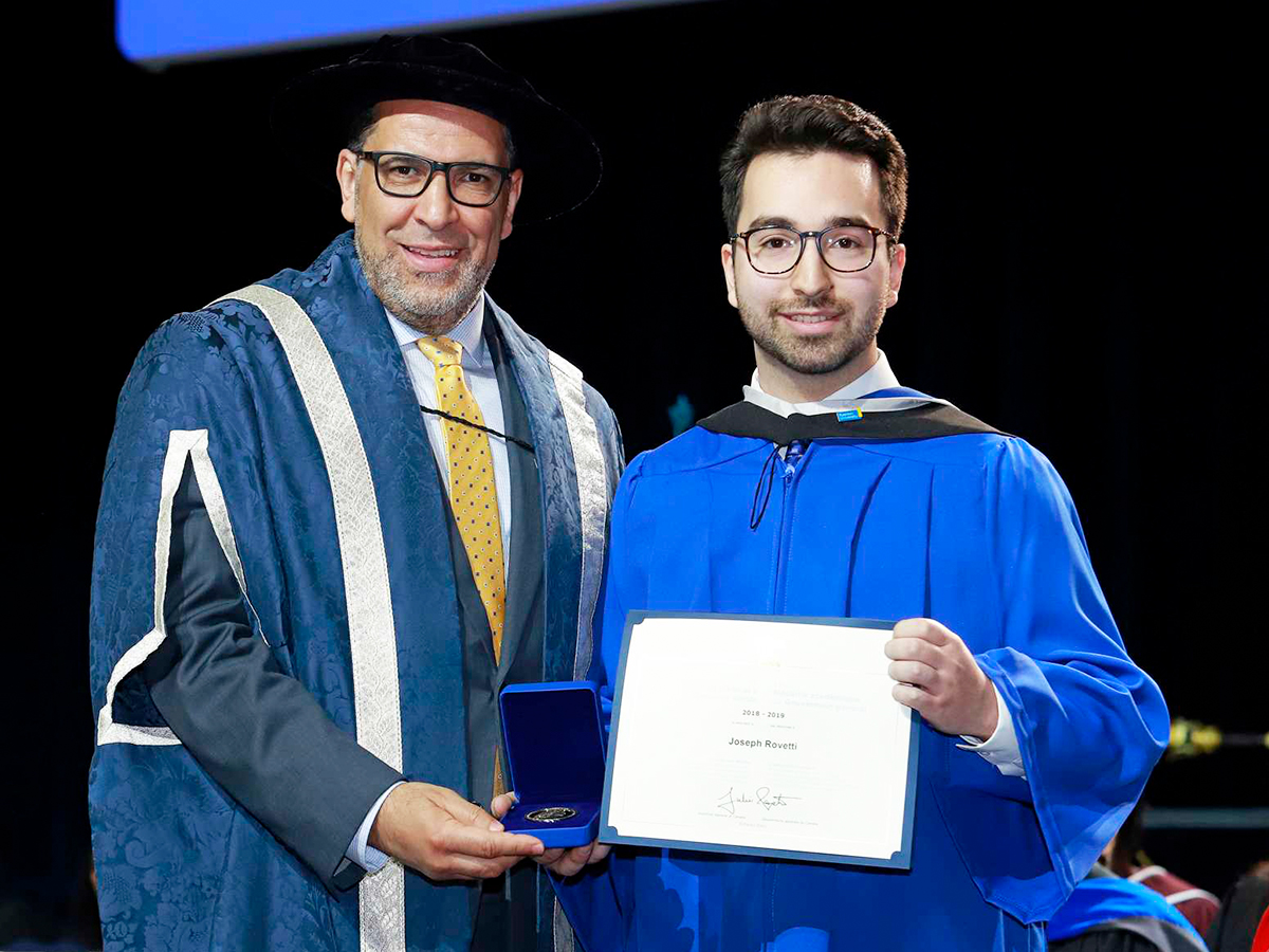 President Mohamed Lachemi presents psychology graduand Joseph Rovetti his Governor General’s Academic Silver Medal at the June 12 convocation ceremony. Photo credit: LifeTouch