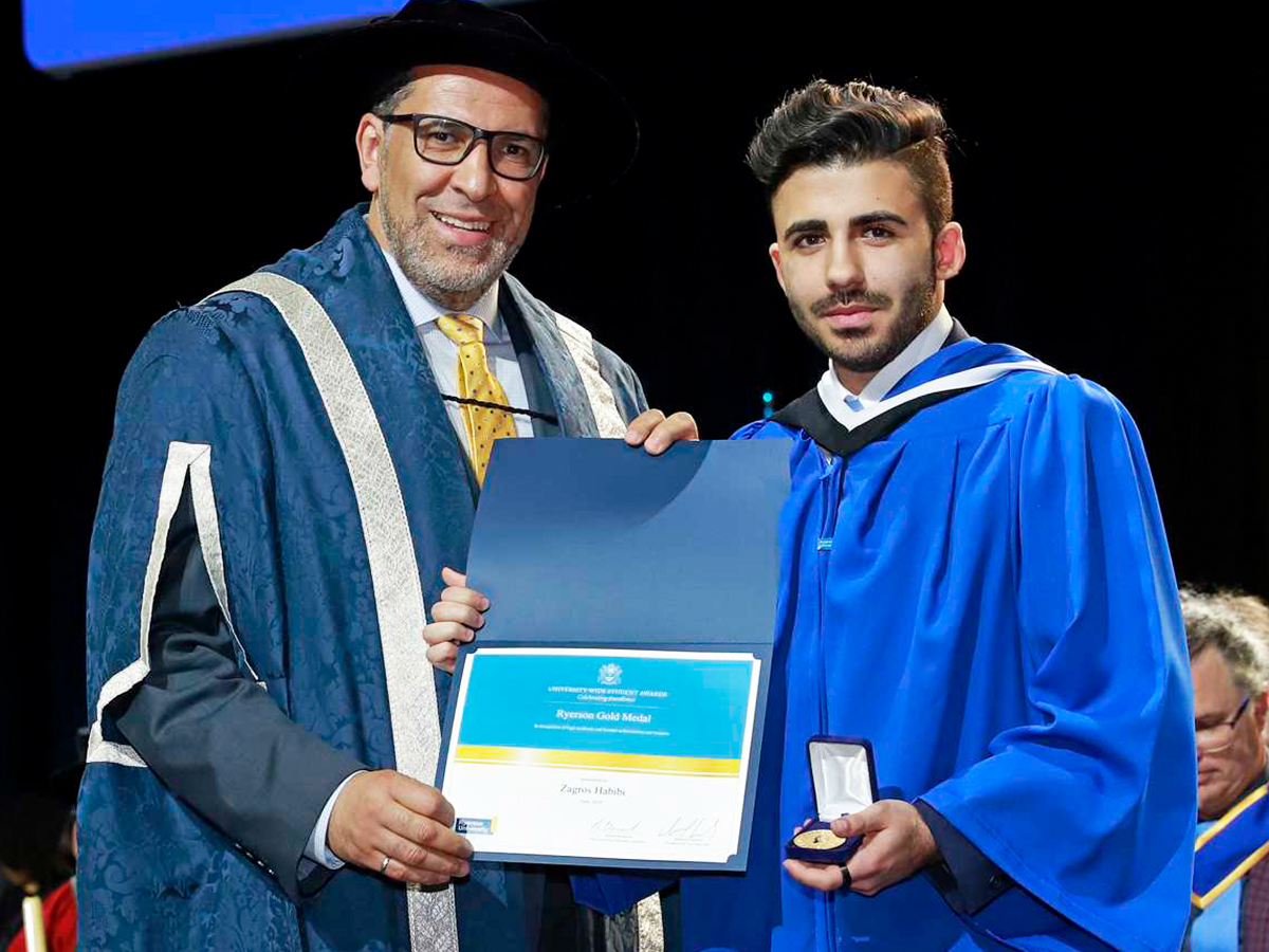 President Mohamed Lachemi poses with Zagros Habibi, a recipient of the 2019 Ryerson Gold Medal (Arts) and a politics and public administration graduand, during his convocation ceremony on June 12.