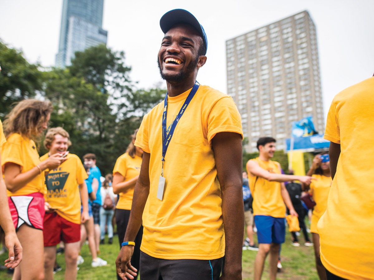 A student laughs at a TMU event in the Quad.