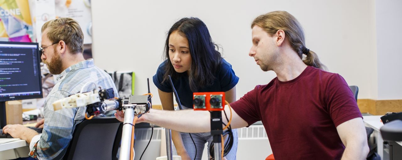 A student working with a supervisor on a mechanical engineering project