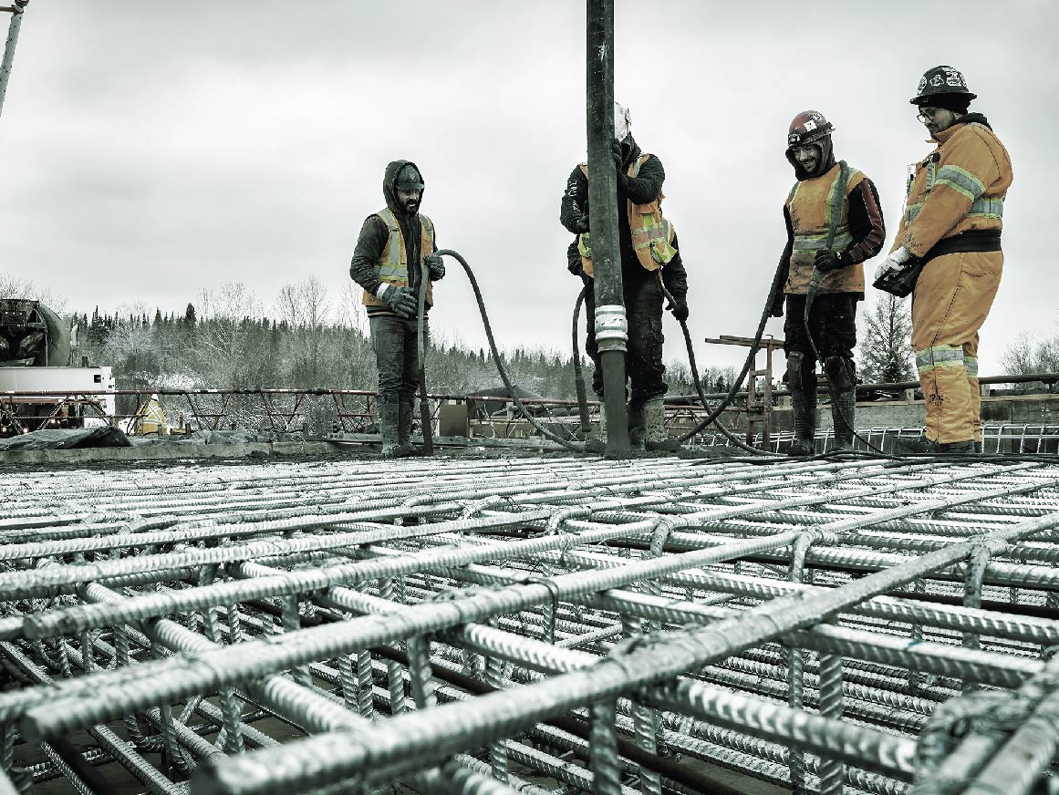 Construction workers pouring concrete 