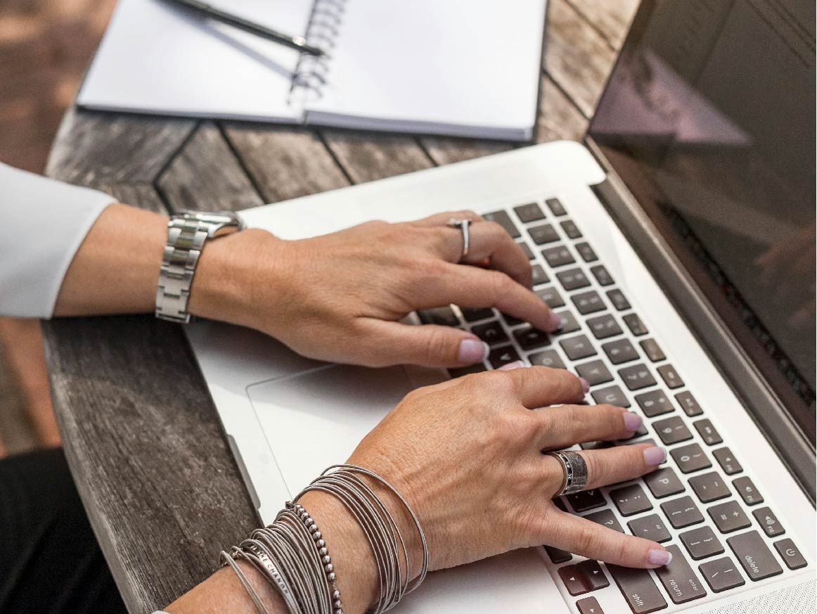 Woman typing on a laptop