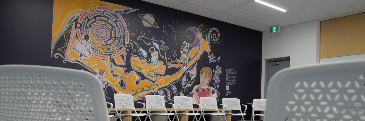Indigenous mural with student chairs in the foreground