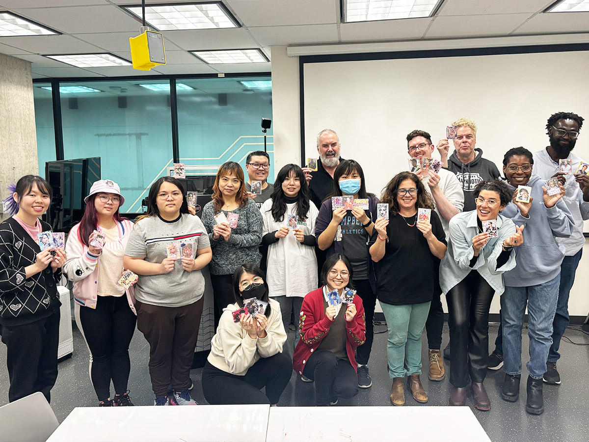 Who's Your Bias? - photocard creation workshop. Group shot of people holding photo cards.