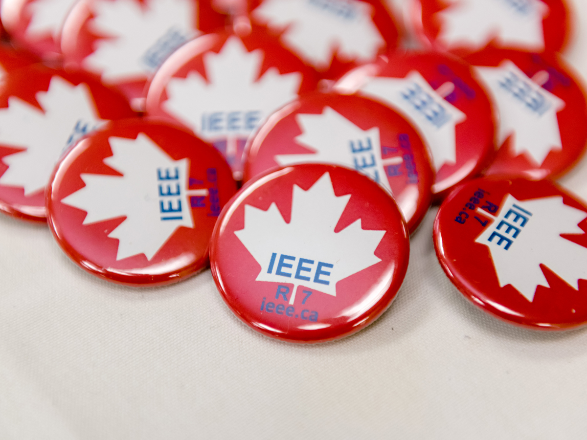 Red buttons with IEEE inside a white maple leaf.