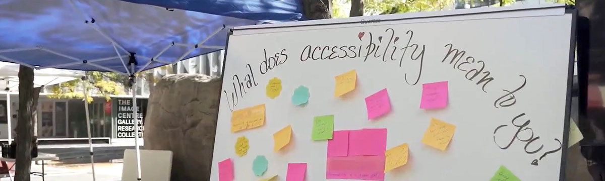 Still from the short film, Across the Universe-city. A whiteboard with sticky notes and the question "what does accessibility mean to you?"