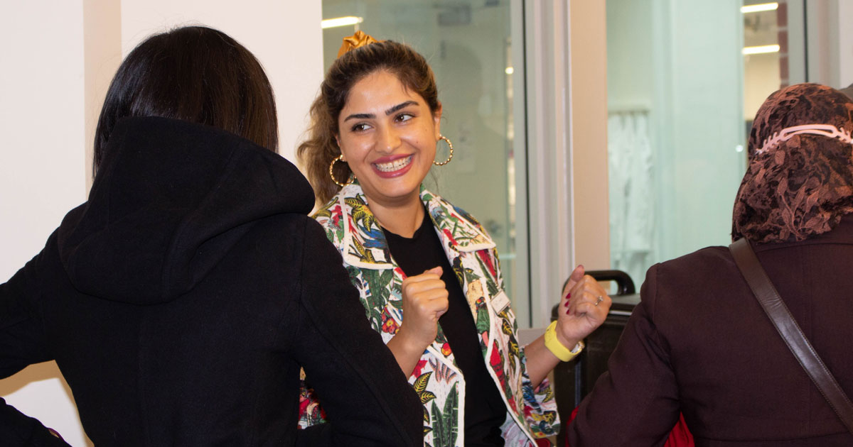 Two Muslim community members talking at an event