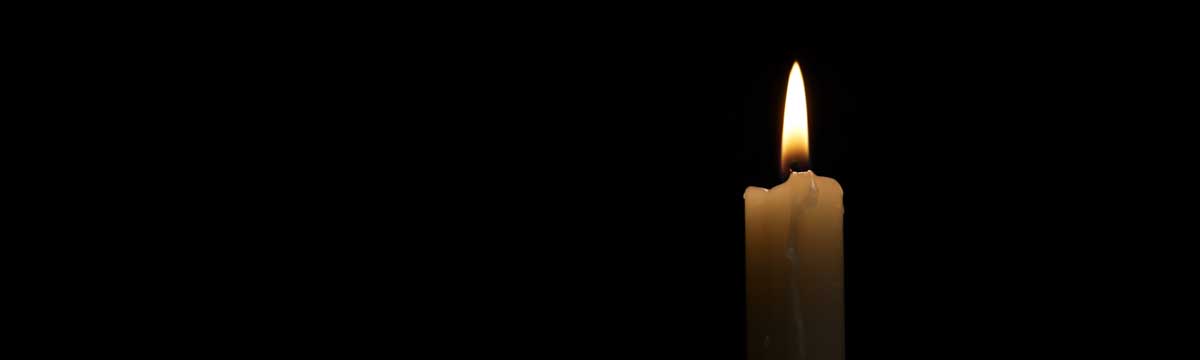 A lit candle, symbolizing remembrance and reflection for the National Day of Remembrance and Action on Violence Against Women.