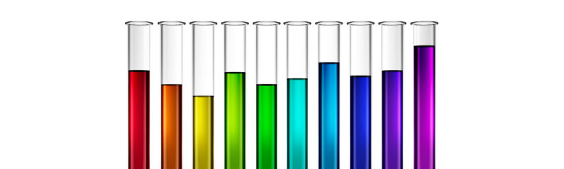 A row of beakers full of different coloured liquids of the Pride flag, red, orange, yellow, green, turquoise, blue and purple.