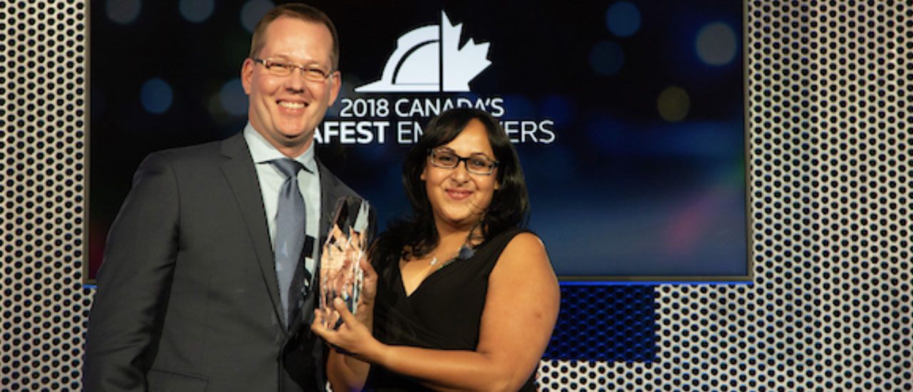 Geeta Sharma receiving Canadaâs Safest Employer Award.