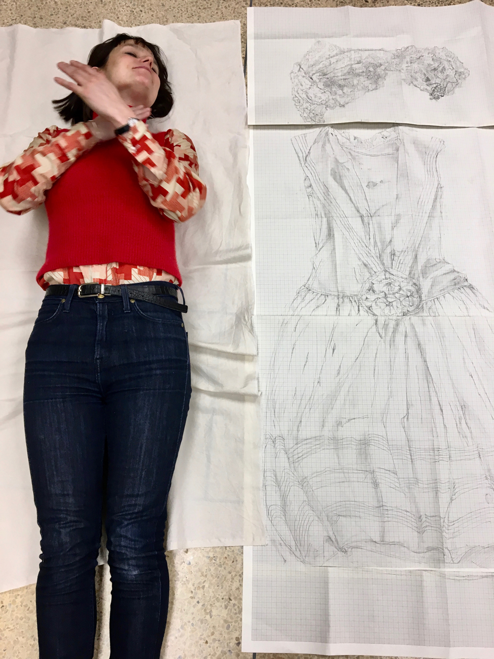 Dr. Sarah Casey lying on the floor next to her meticulous drawing