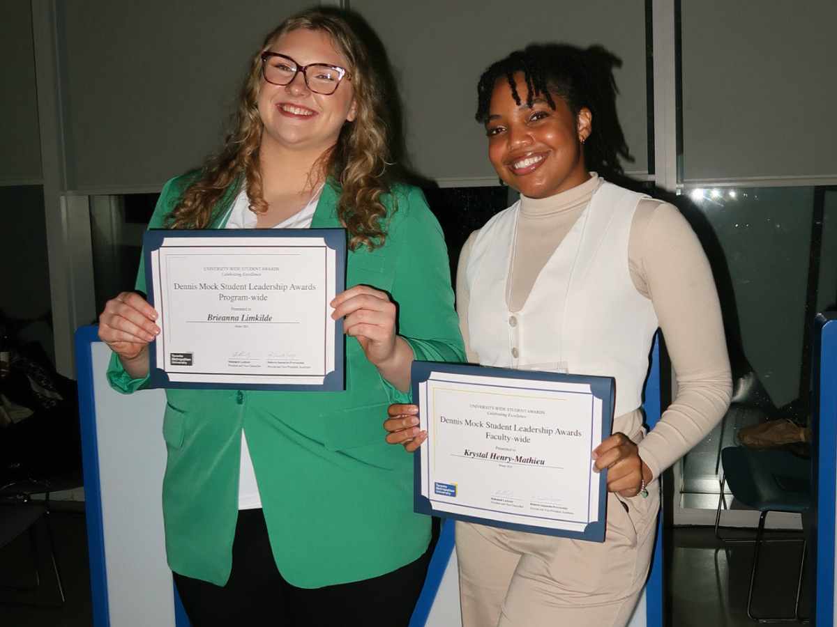 Brieanna Limkilde and Krystal Henry-Mathieu receive Dennis Mock Student Leadership Award certificates at the Student Experience Awards reception.