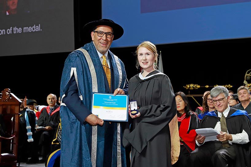 Kira Brown accepts the Toronto Metropolitan University Gold Medal from President Mohamed Lachemi