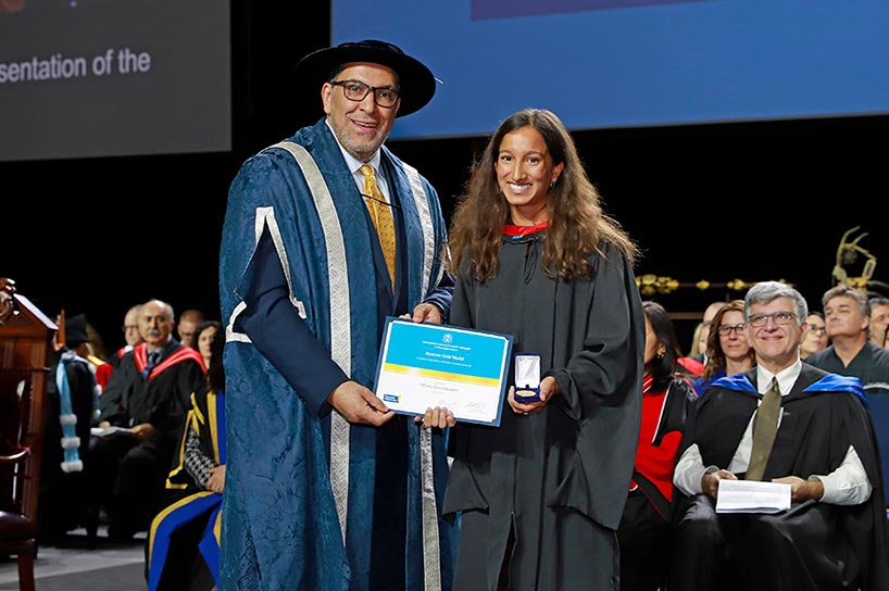 Meera Govindasamy accepts the Toronto Metropolitan University Gold Medal from President Mohamed Lachemi
