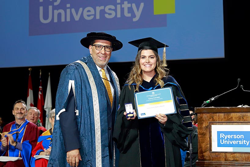 Dr. Victoria Emily Barbosa Hipolito accepts the Toronto Metropolitan University Gold Medal from President Mohamed Lachemi