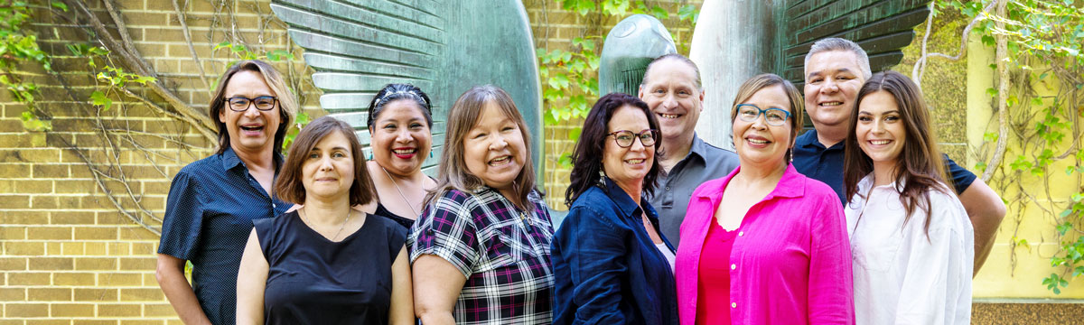 Gdoo-maawnjidimi Mompii Indigenous Student Services team by the Bird of Spring sculpture on the TMU campus.