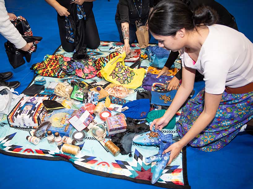 A person placing gifts on a blanket