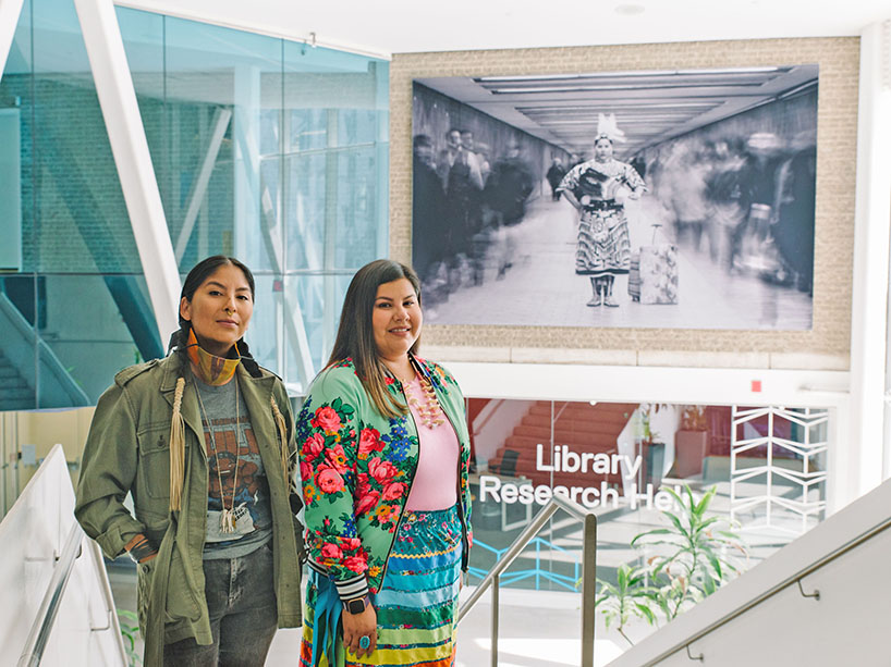  From left: Nadya Kwandibens and Tee Lyn Duke in front of the photograph