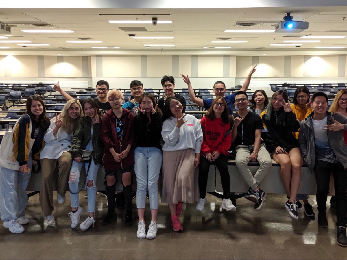 Group photo of Jennifer and Vietnamese students in a classroom. They are smiling. 