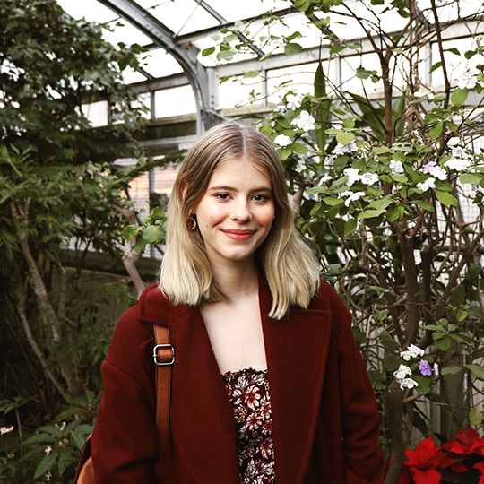 Emma Sandri in a greenhouse