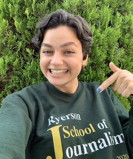 Photo of Giulia Fioani wearing a Ryerson School of Journalism sweatshirt. 