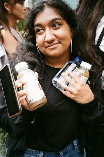 Simran Singh with several bottles